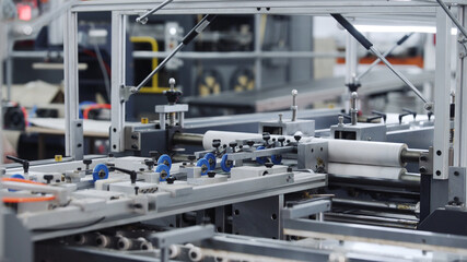 Modern automatic conveyor line for the production of package. Modern factory of production cardboard box. Manufacture of cardboard boxes from paper. Enterprise for production package