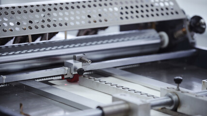 Automatic robotic Conveyor line for the production of boxes. Modern factory of production cardboard box. Manufacture of cardboard boxes from paper. Enterprise for production package