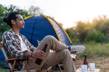 Asian men enjoy camping holidays in the countryside. A lonely man is happy to see nature, travel around.