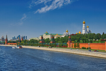 Obraz premium View of the Moscow Kremlin from the Moscow river. Red brick towers and Bell Tower Of Ivan The Great. Grand Kremlin palace. Travel to the capital of Russia. Moscow, Russia.
