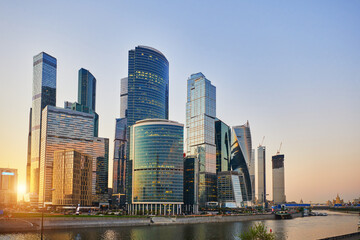 Obraz na płótnie Canvas Urban landscape of Moscow-city, downtown business center with tall buildings. Skyscrapers in light sunset and blue sky at evening. Moscow. Russia.