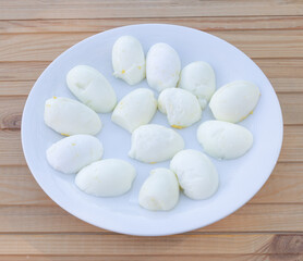 Boiled eggs and cut in half in a plate - Wooden background