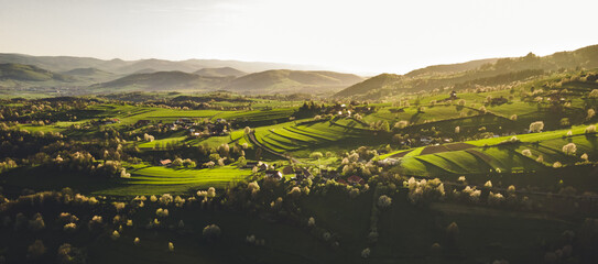 Spring landscape in Slovakia. Polana region, Hrinova. Green spring rural hills landscape, fields, flowering trees, organic farming © Zedspider