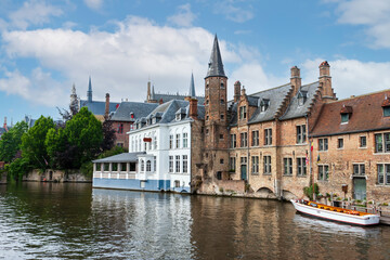 City view with historical houses, church, tower and famous canal in Bruges, Belgium.