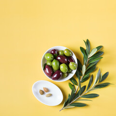 Fresh olives and olive tree branch on a table