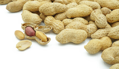 Heap of dried peanuts with peeled, Monkey nuts, Groundnuts, Isolated on white background, Close up