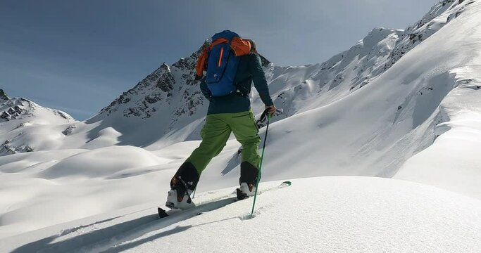 Ski touring with a professional ski mountain guide. Perfect snow conditions and beautiful mountain landscape the perfect place for ski touring in tirol. Cold winter skitour, skiguide 4K flollow camera