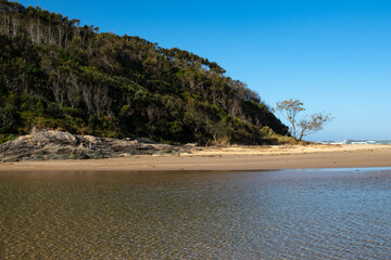 Ocean inlet with moutians and trees in Australia