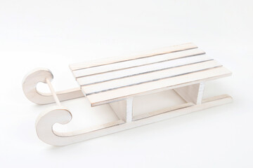 Wooden toy sledge isolated on white background.