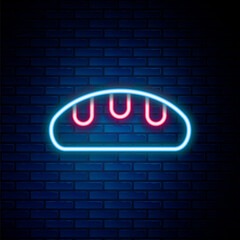 Obraz premium Glowing neon line Bread loaf icon isolated on brick wall background. Colorful outline concept. Vector