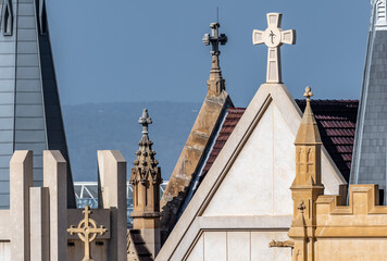 Skyline close up of church roof with crosses and spires interesting shapes of  building exteriors