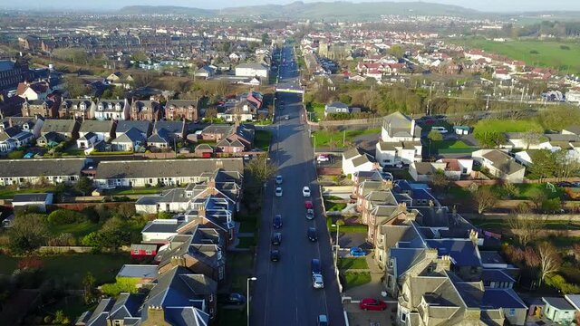Troon city in Scotland. Aerial tilt-up flyback