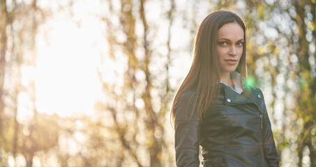 Pretty brunette woman is walking in the park