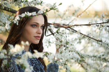 Pretty girl in the spring apple tree garden