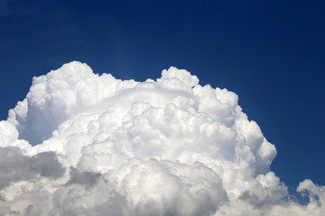 Naklejka na ściany i meble Big white cumulus cloud on blue sky. Background for weather forecast