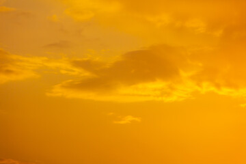 Golden sky with clouds at sunset