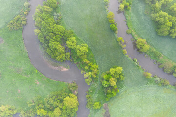 Aerial view of river meander in the lush green vegetation of the delta
Top view of the valley of a meandering river among green fields and forests.
Romantic background concept