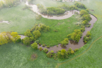 Aerial view of river meander in the lush green vegetation of the delta
Top view of the valley of a meandering river among green fields and forests.
Romantic background concept