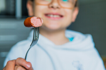 boy and mini sausage for breakfast