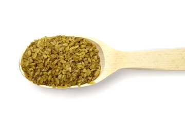 bulgur wheat grain in a wooden spoon isolated on a white background. Vegan healthy food