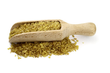 bulgur wheat grain in a wooden scoop isolated on white. Vegan healthy food