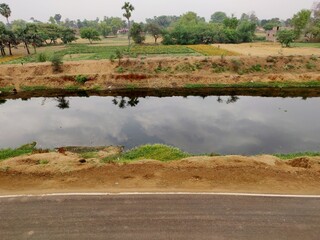 Fototapeta na wymiar Water cannel built adjacent to a village road in a village in Bihar India
