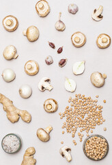 Various organic vegetables, mushrooms and chickpeas on a light gray background. Modern vegan and healthy eating concept.