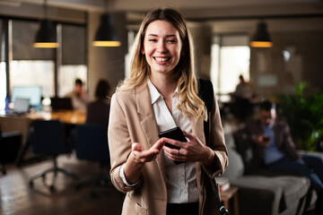 Businesswoman in office. Smiling businesswoman using the phone.