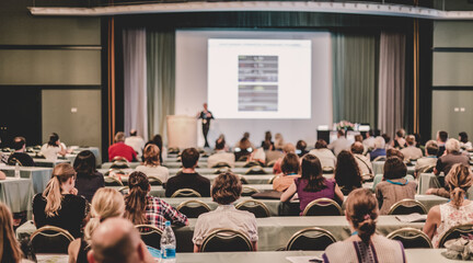 Audience in lecture hall participating at business conference.