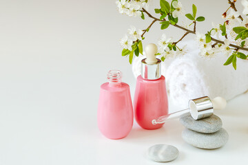 Face serums in pink glass containers. Cream, natural spa cosmetics. copy space