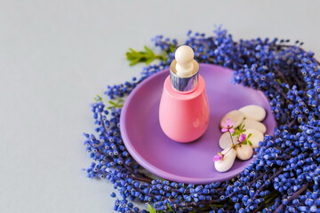 Face serums in pink glass container. Cream, natural spa cosmetics. copy space