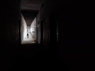 A man walking in Empty Walkway in an old school corridor in an Indian village Bihar