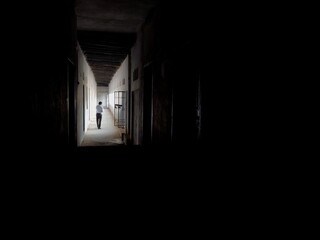 Fototapeta na wymiar A man walking in Empty Walkway in an old school corridor in an Indian village Bihar