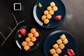 baked rolls in plates on a black textured background