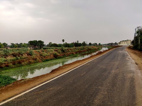 A Village road built adjacent to a Water cannel in a village in Bihar India