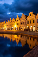 Row of traditional houses in the town of Telč, Czech Republic, at night. These houses on the main square are UNESCO heritage site.