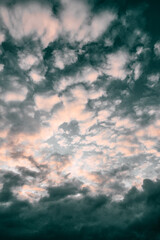 Obraz premium Evening sky with fluffy small clouds after the rain. Overcast over the ocean. Golden hour orange cumulus cloudscape