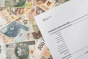 National identification number document in background of zloty and polish coins. PESEL concept of Polish ID. Official personal document