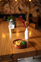 Hawaiian shrimp poke bowl with vegetables on decorated table