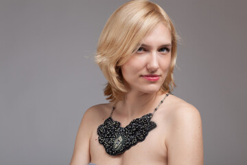 Portrait of Beautiful blonde woman in a beaded necklace