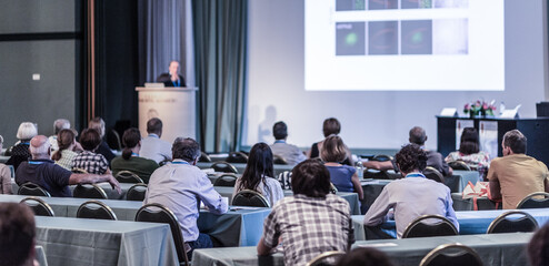 Audience in lecture hall participating at business conference.