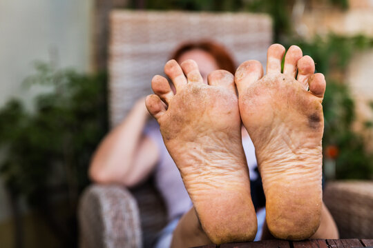 closeup of the bare dirty feet of a adult woman