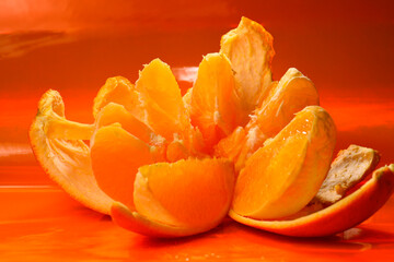 Fototapeta na wymiar juicy orange on an orange background.