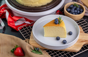 Slice of delicious Taiwanese castella cake with blueberry topping on white plate.