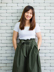 Cheerful Asian woman in stylish apparel in studio
