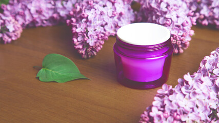 Obraz na płótnie Canvas Organic skin care products on white background with fresh green lilac flowers twigs.