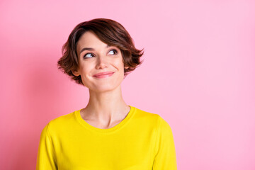 Photo portrait of curious smiling girl bob hairstyle looking empty space isolated on pastel pink color background