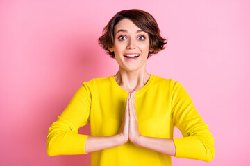 Portrait of attractive cheerful brown-haired girl asking favor isolated over pink pastel color...