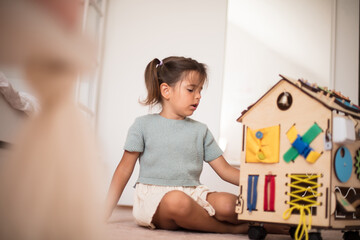 Toddler playing interactive games for good development at home.