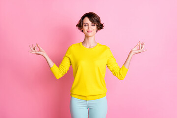 Photo of young beautiful happy smiling cheerful girl relaxing doing yoga with closed eyes isolated on pink color background